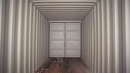 Large metallic white door and white metal corrugated passage with wooden floor. Stock footage....