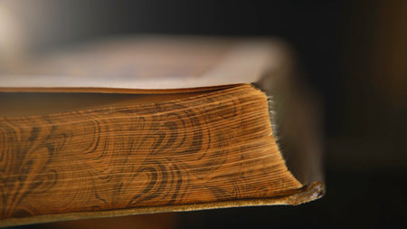 Close-up of unknown person holding in hands open old book and turning the pages. Stock footage. Vintage books, close-up.の写真素材