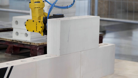 Industrial robot exhibit at work. Media. Bricklayer robot for automated building construction,...