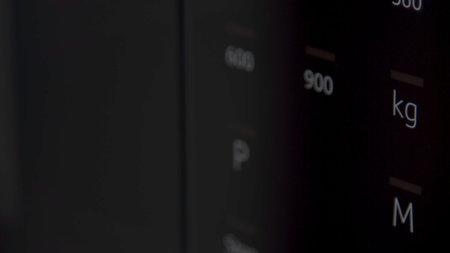 Close up of a black touch panel on a microwave or oven. Household utensils. Details of new technological oven machine with sensor panel, concept of home appliances.の写真素材