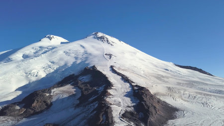 Snowy and icy mountain peaks of glaciers in Austrian Alps at winter. Clip. Aerial view of a snowy...