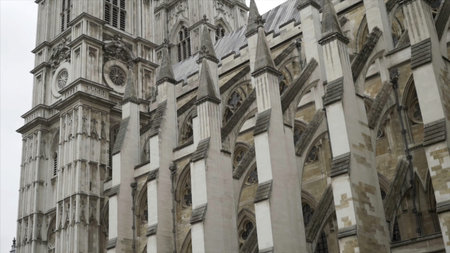 View from the bottom on the Westminster Abbey exterior details against the grey cloudy sky. Action....