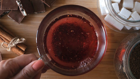 Process of brewing red karkade tea, close up top view. Concept. Cup of freshly brewed fruit tea,...