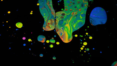 Fantastic surface with multicolored acrylic paints mixed on black background. Stock footage. Close...