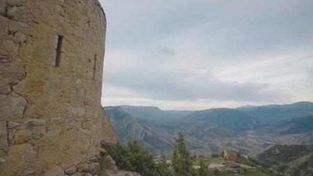 Stone walls of ruins of old city. Action. Historical ruins of old stone town in mountains. Abandoned...