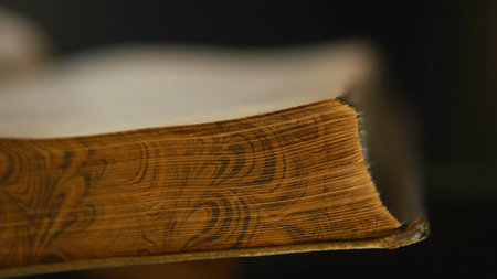 Close-up of unknown person holding in hands open old book and turning the pages.の写真素材