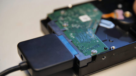 Close up of connecting a chip via an adapter to an external device. Media. Male hand connecting an...
