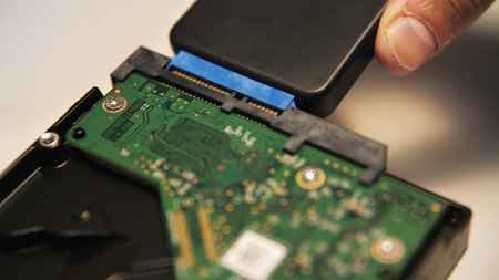 Concept of modern technologies. Media. Close up of man engineer disconnecting adapter from computer...