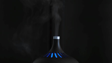 Close-up of humidifier. Action. Black designer humidifier with steam jet on dark background. Stylish...