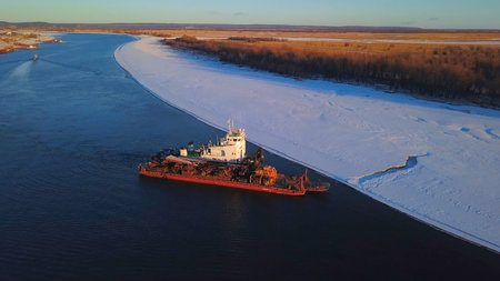 The view from the drone. Clip. A working ship at sea next to the forest and snow .の写真素材