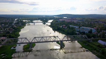 Beautiful view from the helicopter. Clip. View of the river over which there are bridges , next to...