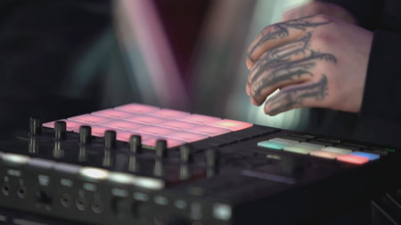 Click colored squares on mixer panel. ART. Hands in dark room are dialing code from multi-colored...