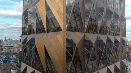Office building windows and aerial view of skyscraper building. Stock footage. Bronze glass facade...
