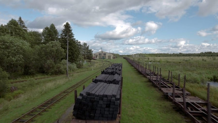 Aerial view of a countryside region on a summer day. Stock footage. Wooden construction stretching...
