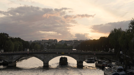 European landscapes. Action. A rainy city with busy traffic and cyclists and bridges over the river.の写真素材