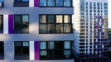 Beautiful new neighborhood. A bright landscape from a drone with new high-rise buildings and next to them the roads on which cars drive and the blue sky overhead.の写真素材