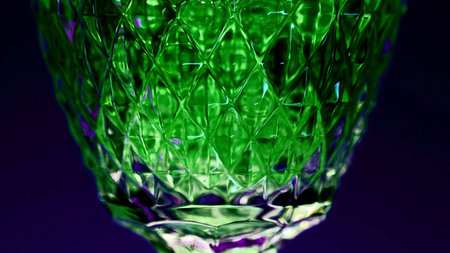 Close up of green drink in a glass on a dark blue background. Stock clip. Silhouette of a glass with a cocktail.の写真素材