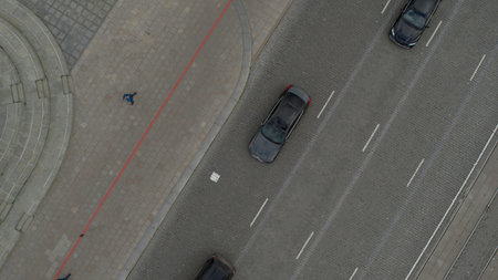 Top view of city asphalt with cars. Stock footage. Flying over city roads and cars. City square with...