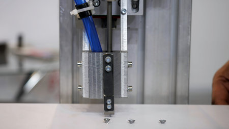 Industrial robot using automatic screwdriver on wooden product. Media. industrial machine at work at...