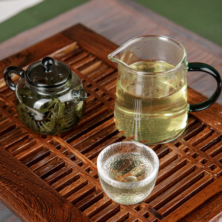 An Elegant Tea Presentation Featuring Exquisite Brews Alongside a Beautiful Teapotの写真素材