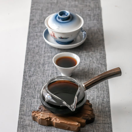 An Elegant Tea Ceremony Is Featuring a Beautiful Teapot and Cups Set Up Gracefully on a Tableの写真素材