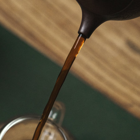 Pouring hot coffee from a stylish traditional kettle creates a delightful experienceの写真素材