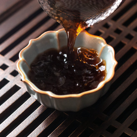 Pouring tea gently into a beautifully crafted traditional Chinese bowl is a delightful experience