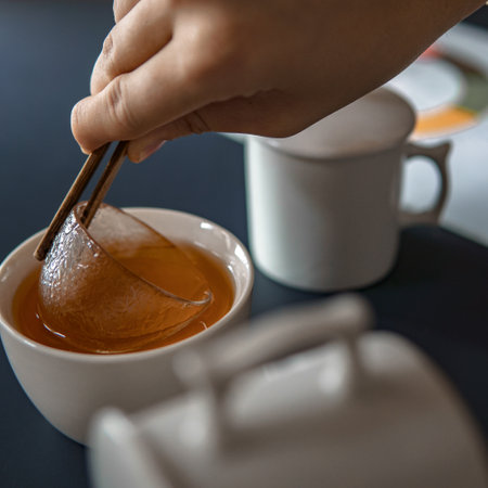 The Artful and Elegant Preparation of Tea Using Honey and Chopsticks in Your Homeの写真素材