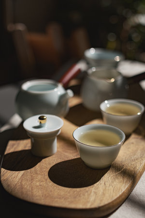 An Elegant Presentation of Tea on a Beautiful Wooden Tray with Fine Porcelain Piecesの写真素材