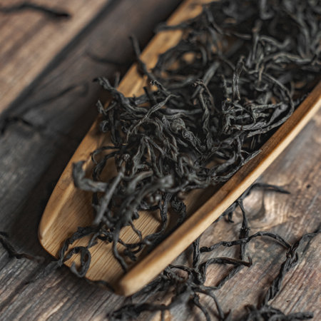 Organic Black Tea Leaves Resting on an Elegant Wooden Spoon for a Premium Experienceの写真素材