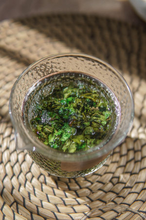 A Refreshing Herbal Tea in a Glass Surrounded by a Vibrant and Natural Background