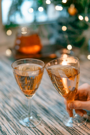 Heres to Celebration Raising Our Glasses with Delightful and Festive Beverages in Handの写真素材