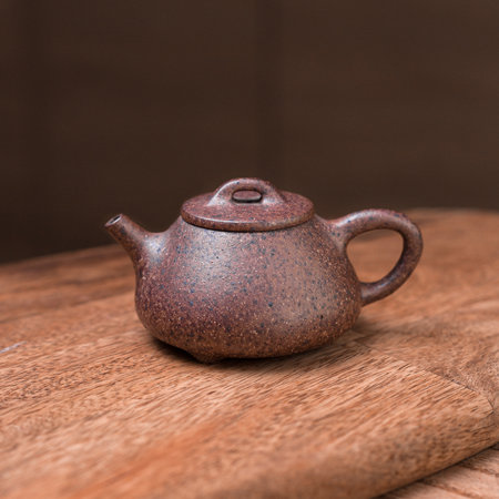 An Elegant Teapot beautifully placed on a Wooden Surface, perfect for Tea Lovers everywhereの写真素材