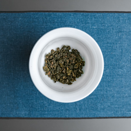 A bowl filled with freshly dried green tea leaves that emanate rich aromas and health benefitsの写真素材