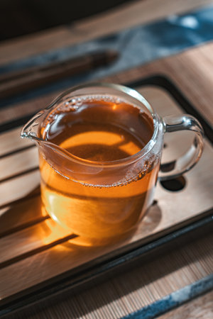 An Elegant and Beautiful Teapot with Herbal Tea Presented on a Wooden Tray for Enjoymentの写真素材