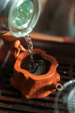 An Elegant Teapot Pouring Ceremony, Embracing Timeless Traditional Style and Ritualsの写真素材