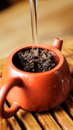 Brewing Tea in a Beautifully Crafted Traditional Teapot for a Truly Enjoyable Experienceの写真素材