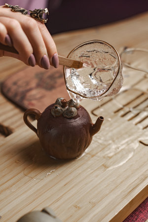 An Elegant Tea Ceremony with a Unique Teapot and Art of Water Pouring for a delightful experienceの写真素材