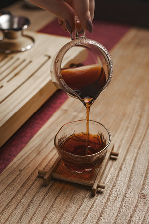 The Elegant Tea Pouring Ritual Awaits You in a Cozy and Inviting Setting for Allの写真素材