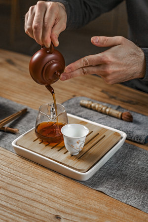 The Tea Ceremony is an art of elegantly pouring tea with a beautiful teapot and fine cupsの写真素材