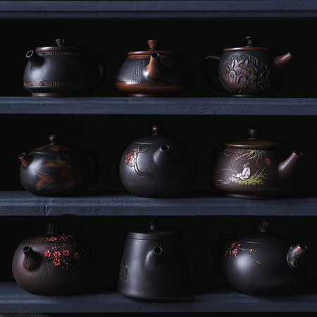An Artistic and Elegant Display of Traditional Asian Teapots Arranged on Beautifully Crafted Shelvesの写真素材