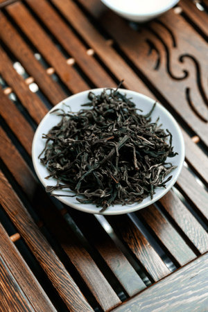 Dried Black Tea Leaves Beautifully Arranged on a Wooden Surface for Display and Enjoymentの写真素材