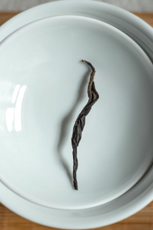 A Dried Vanilla Bean Presented Elegantly on a White Plate A True Culinary Delight
