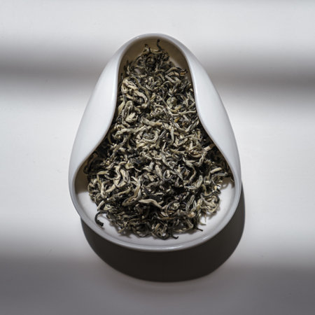 An Elegant and Visual Display of Various Dry Tea Leaves Presented in a Unique Bowl Designの写真素材