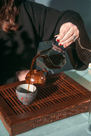 Enjoy the Elegant and Artful Tea Pouring Experience in a Traditional and Inviting Setting
