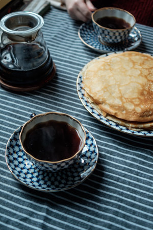 A Cozy Breakfast Scene Featuring Warm Coffee and Fluffy Pancakes for Ultimate Comfortの写真素材