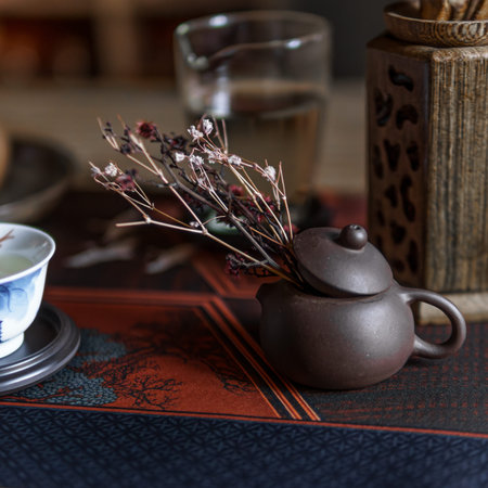 An Elegant Teapot Arrangement Featuring Dried Flowers and Beautiful Glassware Accents