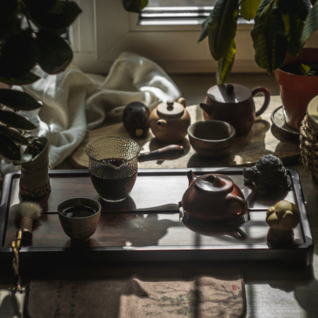 An Elegant Tea Setup Featuring a Beautiful Ceramic Teapot Bathed in Soft Natural Lightの写真素材