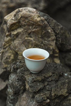 Enjoy a Serene Tea Moment on a Natural Rock Surface, Embracing Comfort and Calmnessの写真素材