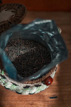 A closeup photo of a woven basket with a blue bag filled with diverse dried itemsの写真素材